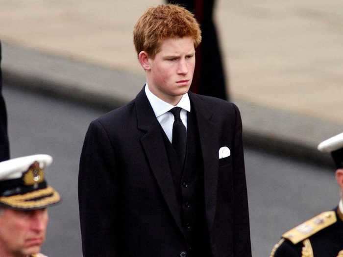 AGE 17: Harry walks behind the Gun Carriage bearing the coffin of the Queen Mother on April 9, 2002.