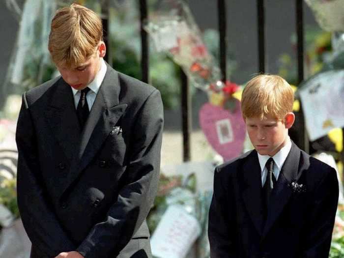 AGE 12: Prince William and Prince Harry bow their heads as their mother