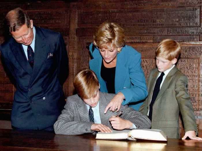 AGE 10: Harry looks on as Prince William signs the traditional entrance book at Eton College on his first day of school on September 6, 1995.