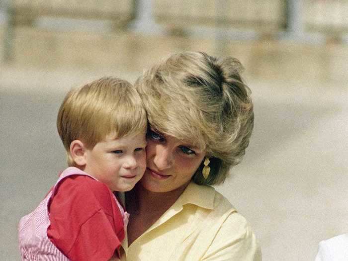 AGE 2: The Princess of Wales holds Prince Harry at the Royal Palace, Majorca, Spain on August 9, 1987.