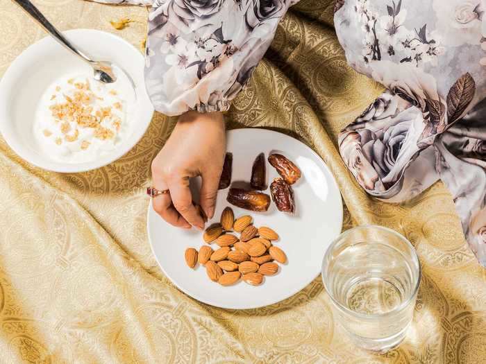 The fast is broken with water and foods like nuts, dates, and yogurt.