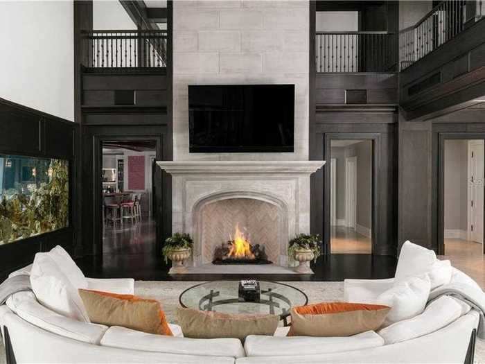 And it comes with stunning features, including a massive stone fireplace and an aquarium built into the wall.