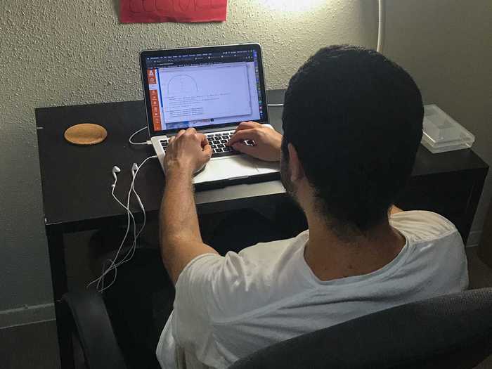 After taking a shower and preparing for class, Vasquez reviews the class material before his 10 a.m. lecture.