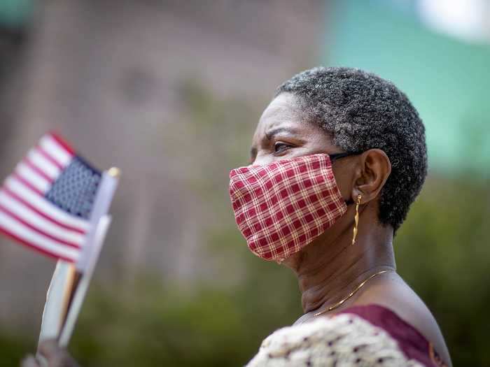 Margaret Marwieh, who came to the US from Liberia, attends a socially distanced ceremony in Minneapolis.