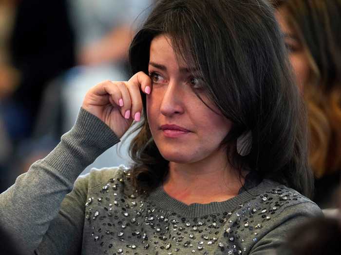 In Salt Lake City, a woman wipes a tear away as she is sworn in as a US citizen.