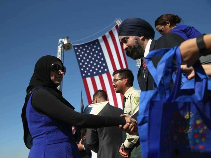 A group in New Jersey gathers to shake hands during a ceremony.