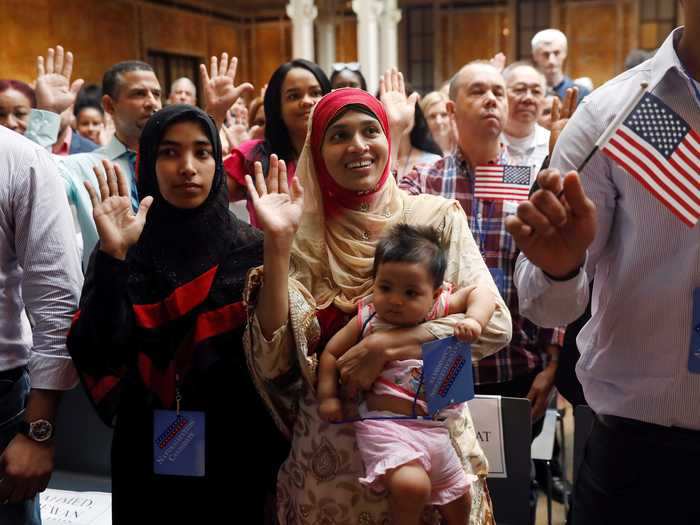 Also that year, new citizens smiled during the pledge of allegiance at the New York Public Library in Manhattan.