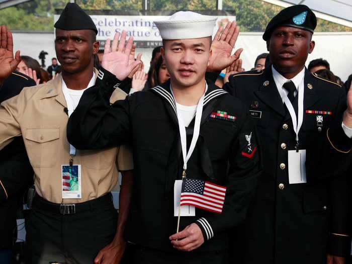 Zuyu Nu, who was serving with the US Navy, takes the oath of citizenship at the Statue of Liberty in New York City.