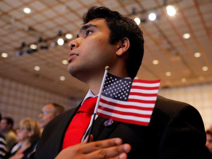 Stallone Laurel Dias recites the pledge of allegiance after taking the oath to become a US citizen in Boston.