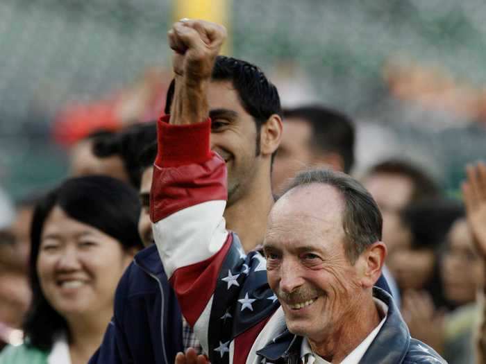 Robert Moshenko, who is originally from Canada, wears an American flag jacket during his ceremony to become a citizen.