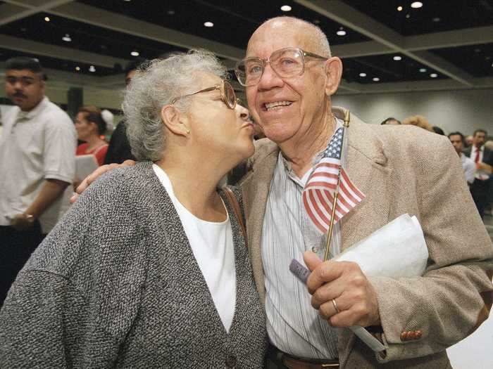 Maria E. del Rio kisses her husband Raul del Rio as he becomes a citizen. Originally from Mexico, he waited 53 years to become a citizen.