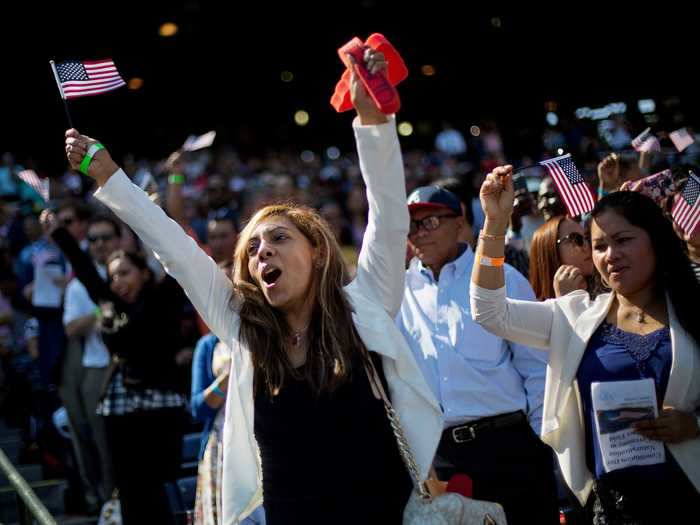 Silvia Hunt cheers as Mexico is announced during a naturalization ceremony.