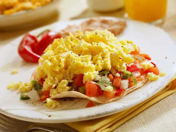 Start your day off by whipping up some scrambled eggs in a tortilla.