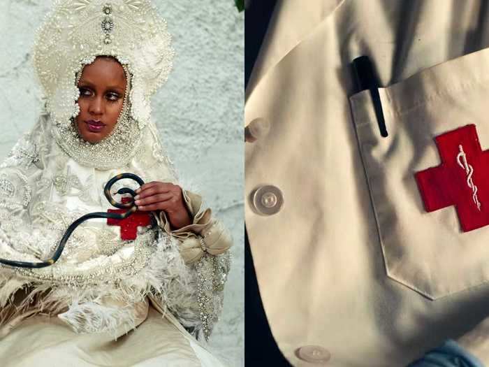 The doctor holds a snake in front of a red cross, which reappears as the insignia on her lab coat.