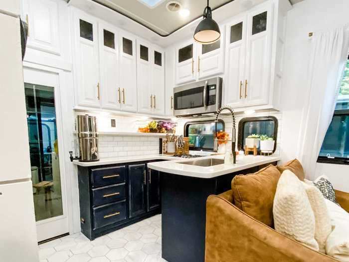 The kitchen sits behind the living room.