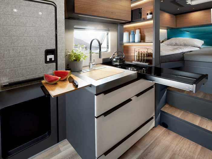 The L-shaped kitchen — which sits between the living area and the bedroom — can be upgraded with the Premium Kitchen package. This allows the unit to extend and expand when in use.