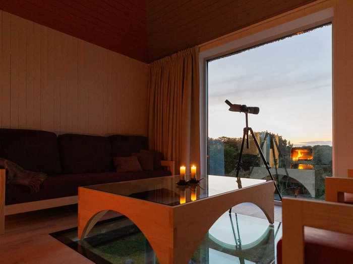 A cozy living space is equipped with a monocular telescope.