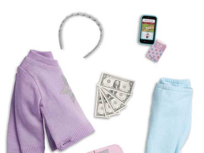 One glance at the "Truly Me" accessories — a tiny card-holder, play cash, and a miniature cell phone with interchangeable screen-savers — shows how the decades-old doll brand has changed with the times.