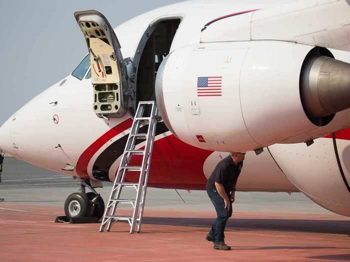 A fuel truck tops off the gas tank while pilots take a quick restroom break.