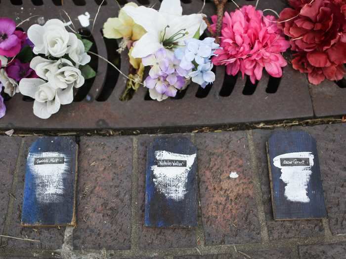 Names of Black people who have been killed by police are placed in a circle around Taylor