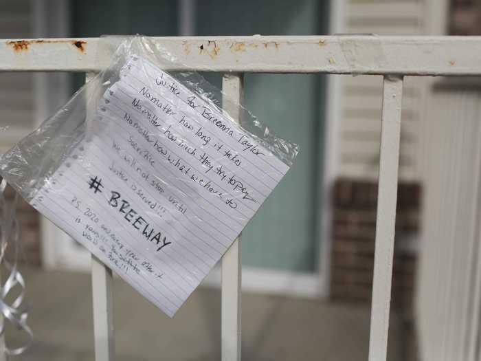 A handwritten note hangs as part of a memorial for Taylor at the apartment where she died.