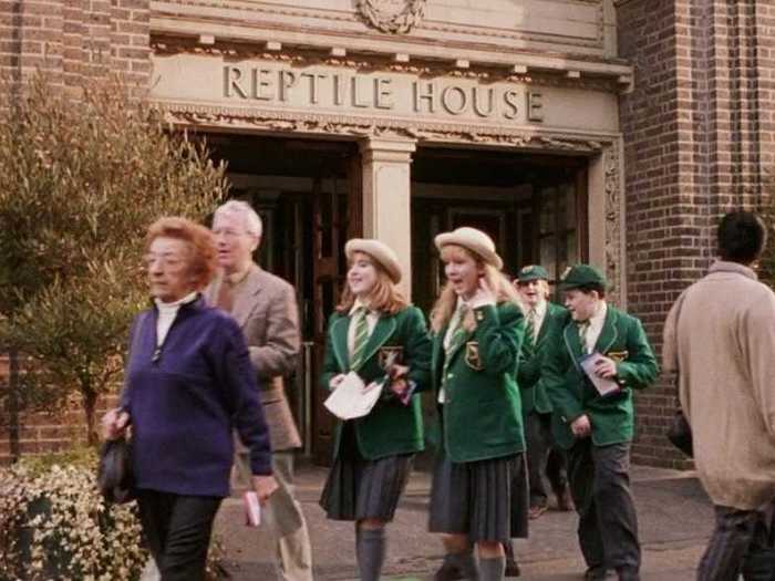 A group of school students in Slytherin colors exit the reptile house when Harry and the Dursleys visit London Zoo.