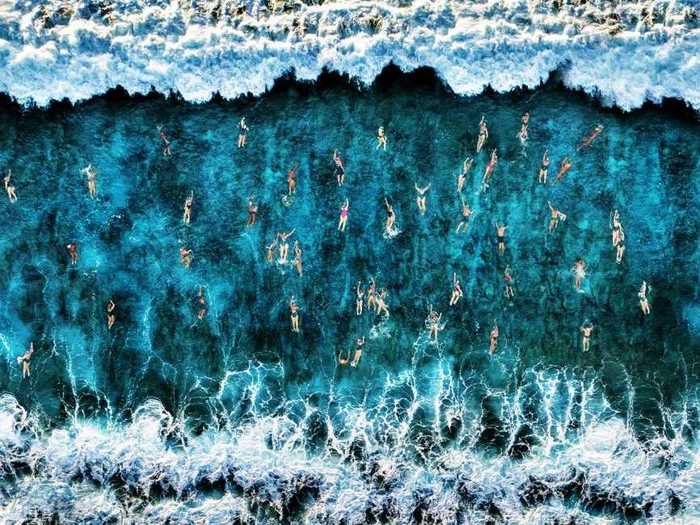 In "On the Sea," Roberto Corinaldesi captured the nail-biting moment dozens of swimmers headed into a wave.