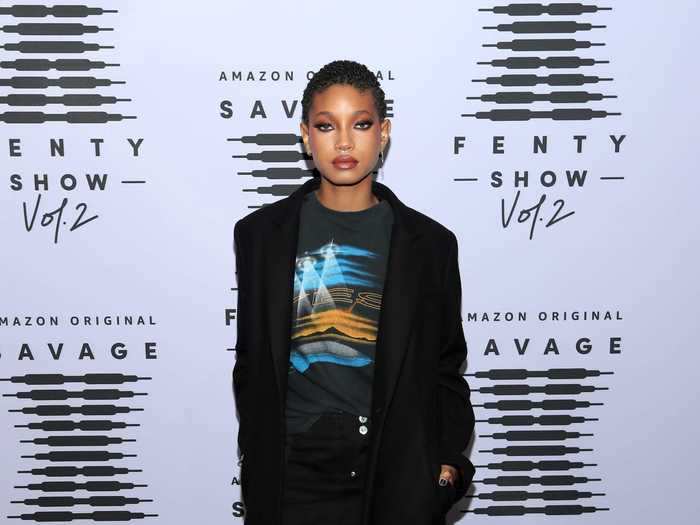 Willow Smith was photographed wearing a black coat with a graphic tee and black miniskirt underneath.