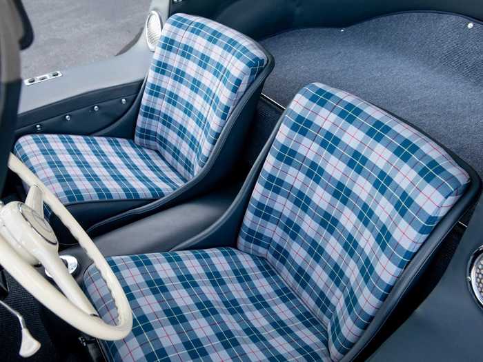 The blue leather of the door sills, door panels, and bolsters looks great with the blue-on-gray plaid cloth seat covers.