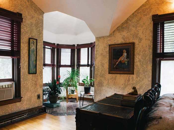 The bedroom also has a reading nook filled with greenery.