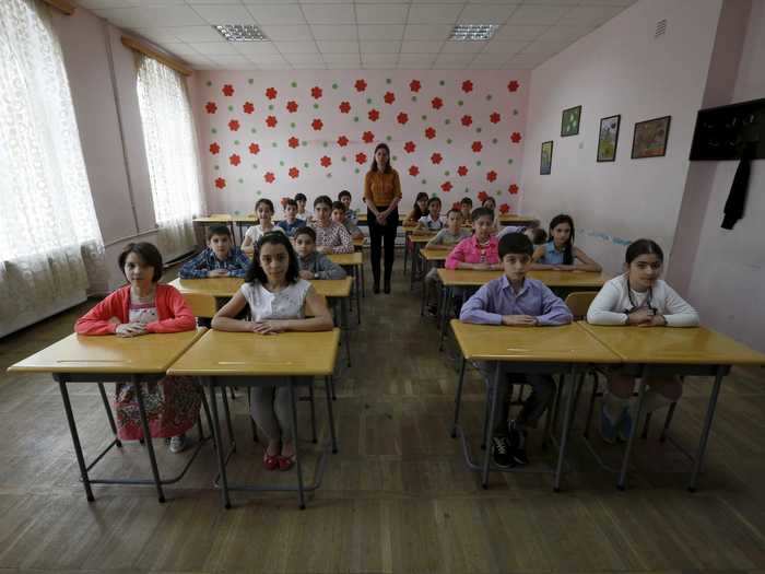 Teacher Ekaterine Tsipuria is pictured with schoolchildren at a public school in Tbilisi, Georgia.