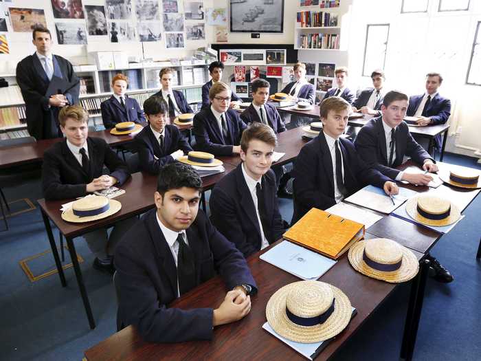 The school uniform in Old Schools at Harrow School in Middlesex, UK, includes straw hats.