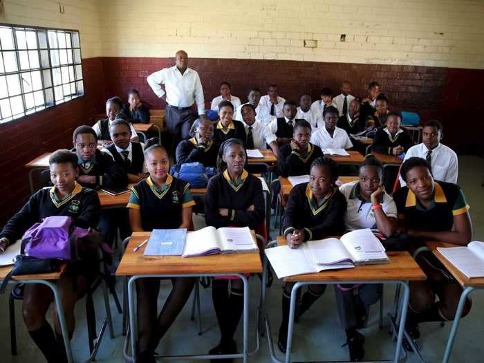 Teacher Reginald Sikhwari posed for a picture with his 11th-grade students in Soweto, South Africa.