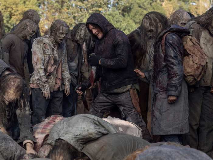 Daryl sticks close to Kelly to make sure she gets through the sea of walkers.