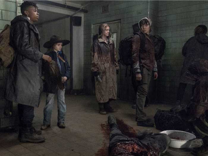 Daryl, Carol, Kelly, Luke, and more cover themselves in walker guts to successfully cross through a horde of of the undead undetected.