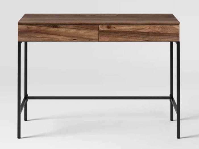 Use this wood writing desk for work or as a buffet table for entertaining guests.