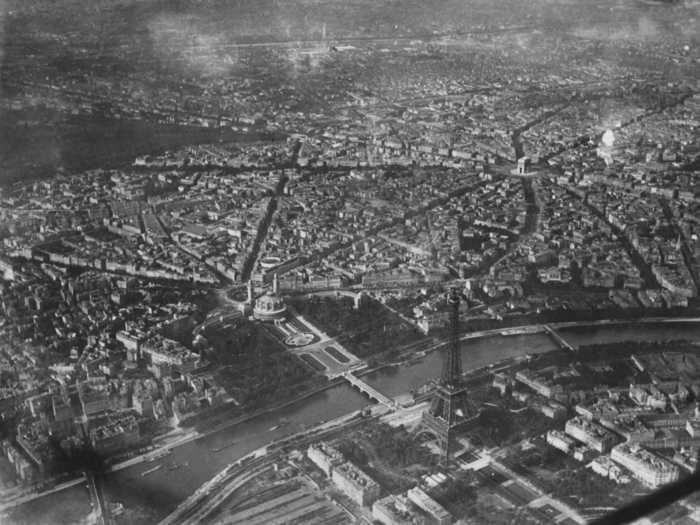 An aerial shot of Paris shows a city that has been structurally unchanged over the course of 100 years.