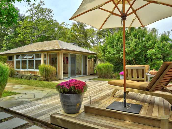 The home has bluestone walkways and mahogany decks surrounded by the property