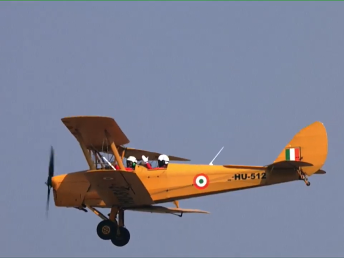 Tiger Moth’s pilots were seen waving to the audience as they flew above the air base..