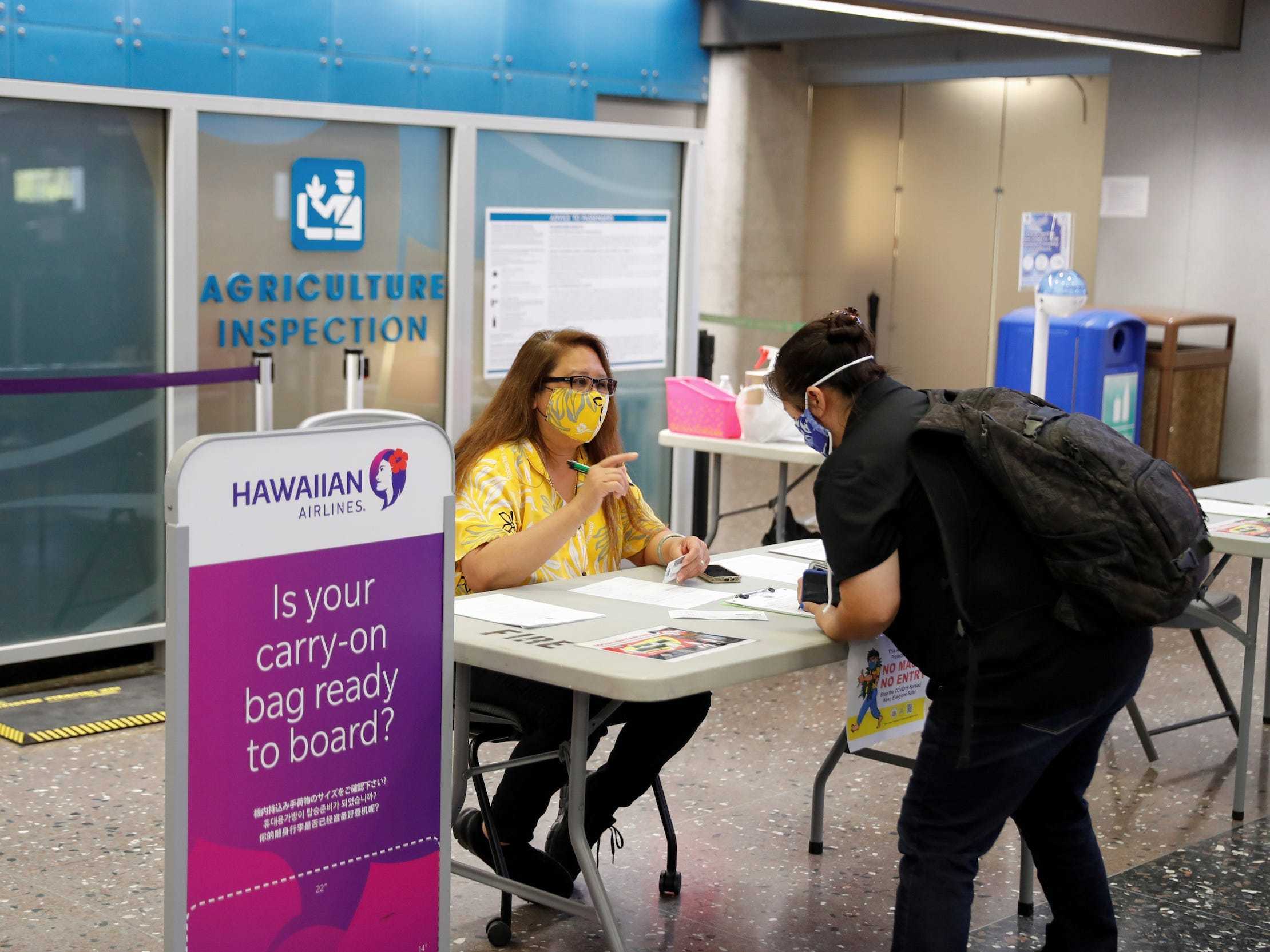 A traveler checks in with airport authorities at the Daniel K. Inouye International Airport during the spread of the coronavirus disease (COVID-19) in Honolulu, Hawaii, U.S., April 28, 2020. Picture taken April 28, 2020.