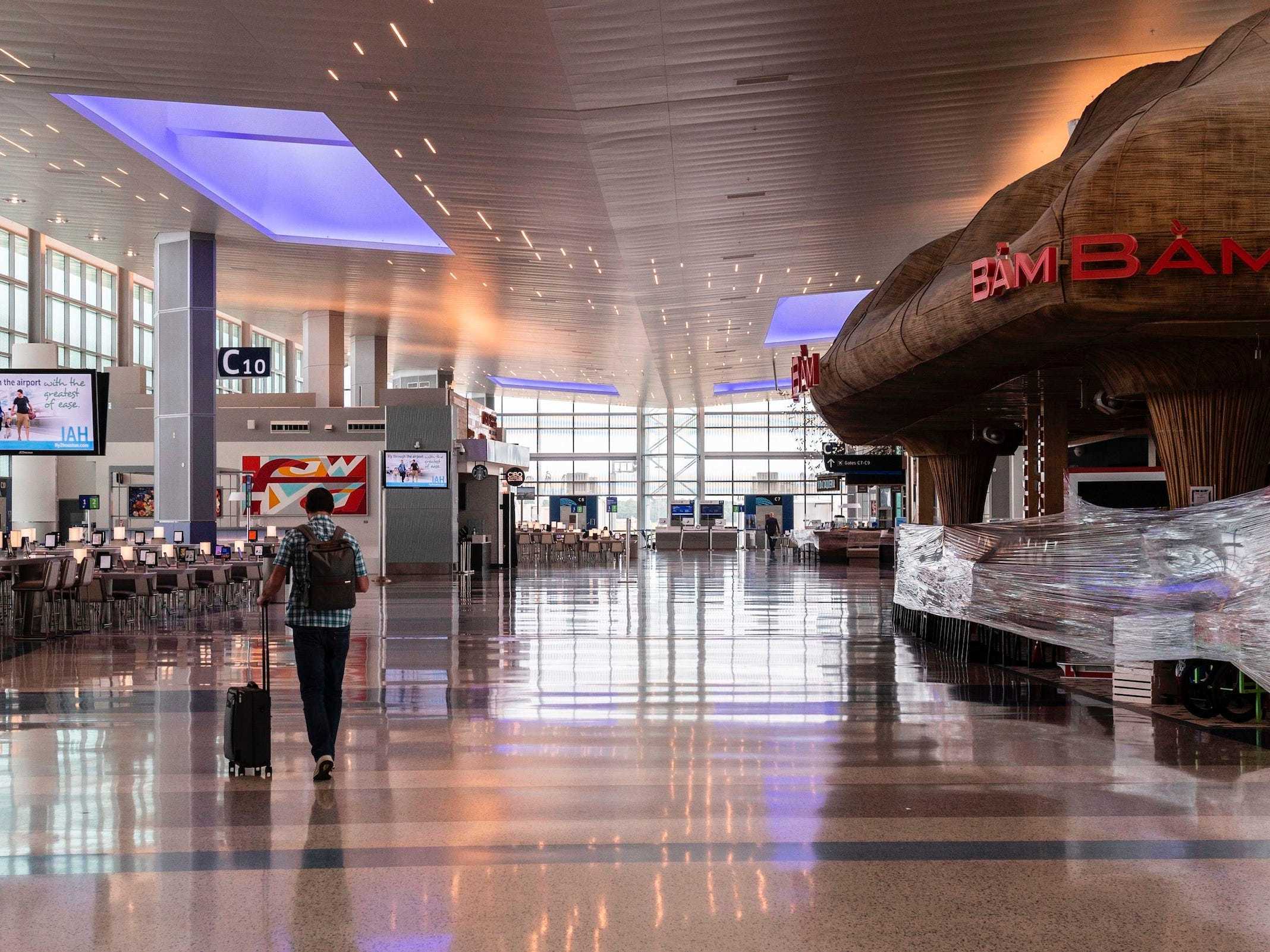 A man walks through an empty terminal at the George Bush Intercontinental in Houston, Texas, on June 10, 2020.