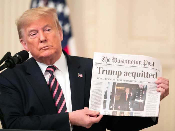 President Donald Trump held up a copy of the Washington Post after he was acquitted of two articles of impeachment in February 2020.