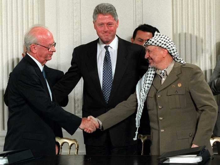 President Clinton is seen grinning following the signing of the Mideast Accord between Israel and Palestine in 1995.