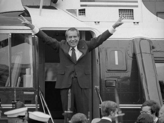 Nixon gestured the peace sign after resigning from the presidency in 1974.