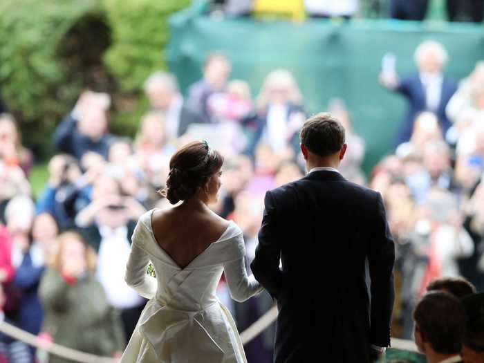 This image gives a rare glimpse at the couple looking out onto the well-wishers in the crowd, who gathered outside the chapel.