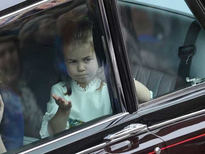 Not everyone seemed pleased by the waiting cameras at the wedding. Princess Charlotte can be seen here making faces at the photographers.