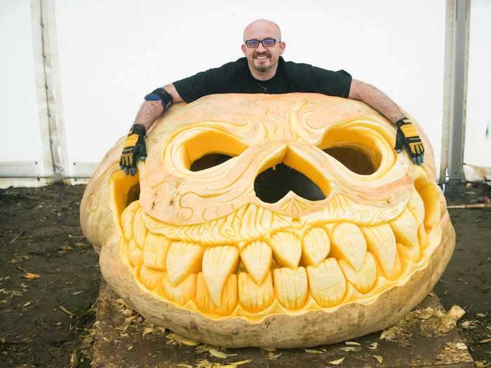 Pumpkin carver Christian Russell posed with his world record-breaking jack-o