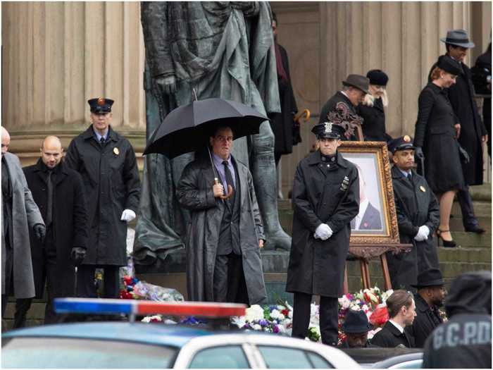 The set photos show a funeral scene of some description