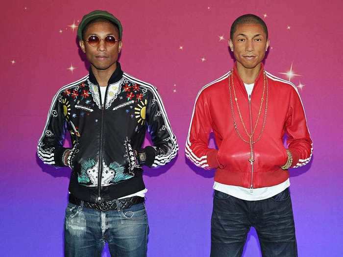 Pharrell Williams struck the same pose as his figure on a visit to Madame Tussauds New York.