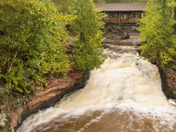 The Horton Covered Bridge sits atop the Lower Falls at Amnicon Falls State Park in Wisconsin.